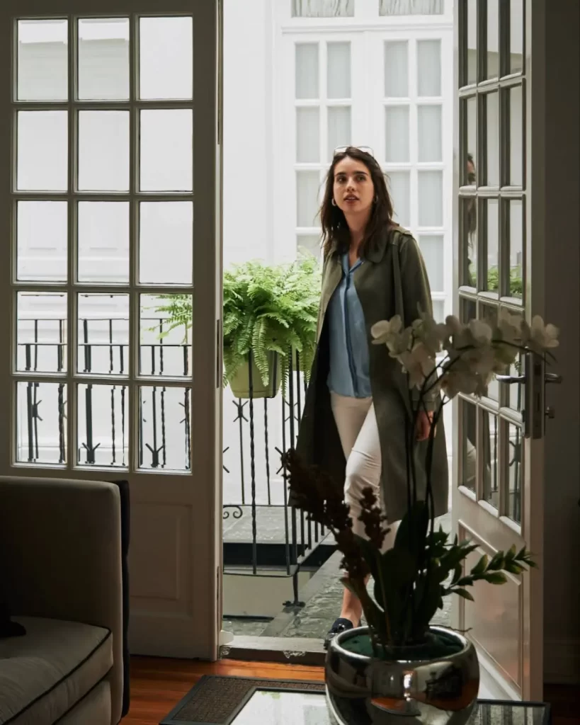 Guest entering the elegant courtyard of Casa Goliana boutique hotel in Mexico City with bright natural light and classic architecture
