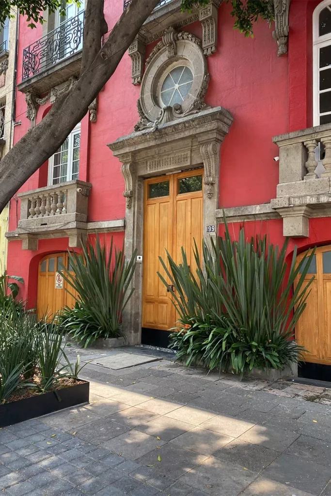 Elegant historic mansion on a tree-lined street in Roma Norte, reflecting the intimate charm of boutique hotels in Mexico City.